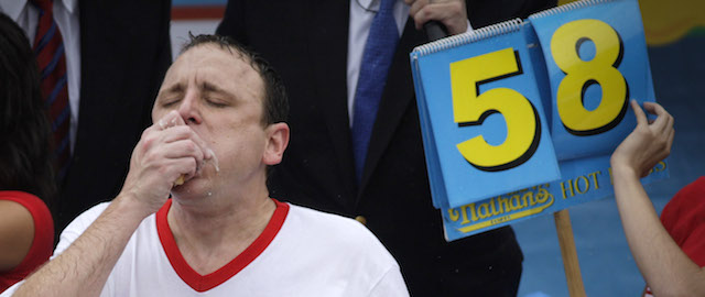 NEW YORK, NY - JULY 04: Joey Chestnut celebrates after winning the 98th annual Nathan's Famous Hot Dog Eating Contest at Coney Island on July 4, 2014 in the Brooklyn borough of New York City. Chesnut won his eighth straight Nathan's Hot Dog Eating Contest with 61 hot dogs. (Photo by Kena Betancur/Getty Images)
