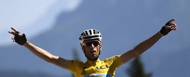 Italy's Vincenzo Nibali wearing the overall leader's yellow jersey celebrates as he crosses the finish line at the end of the 197.5 km thirteenth stage of the 101st edition of the Tour de France cycling race on July 18, 2014 between Saint-Etienne and Chamrousse, central eastern France. AFP PHOTO / ERIC FEFERBERG (Photo credit should read ERIC FEFERBERG/AFP/Getty Images)