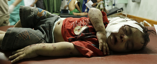 A Palestinian child, wounded in an Israeli strike on a compound housing a UN school in Jabalia refugee camp in the northern Gaza Strip, is pictured at Kamal Adwan hospital in Beit Lahia early on July 30, 2014. Israeli bombardments early on July 30 killed "dozens" of Palestinians in Gaza, including at least 16 at a UN school, medics said, on day 23 of the Israel-Hamas conflict. AFP PHOTO / MOHAMMED ABED (Photo credit should read MOHAMMED ABED/AFP/Getty Images)