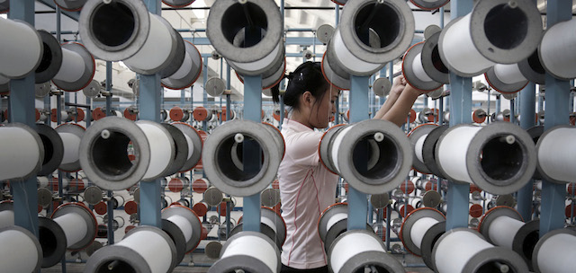 A North Korean woman works at the Kim Jong Suk Pyongyang textile factory, Thursday, July 31, 2014 in Pyongyang, North Korea. This is the country's largest textile factory with 8,500 workers, where eighty percent of them are women.(AP Photo/Wong Maye-E)