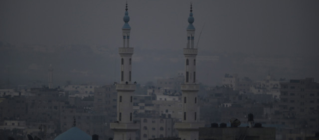 Minarets from a mosque are seen in this view of Gaza city, early Monday, July 28, 2014. Monday marked the beginning of the three-day Eid al-Fitr holiday, which caps the Muslim fasting month of Ramadan. Muslims usually start the day by visiting cemeteries, to pay their respects to the dead, and then exchange family visits. (AP Photo/Lefteris Pitarakis)