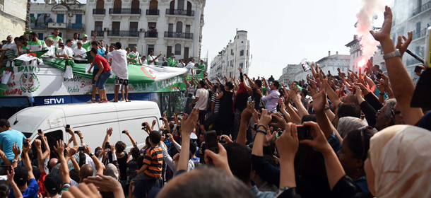 Algerian national team players are greeted by fans upon their return from the 2014 FIFA World Cup in Brazil, on July 2, 2014, in the capital Algiers. Extra-time goals by Andre Schuerrle and Mesut Ozil sealed Germany's 2-1 win over Algeria in the last 16 clash to put the three-time winners into the World Cup quarter-finals. The victory at Porto Alegre's Beira-Rio Stadium was Germany's first over Algeria at the third attempt, but this was a far from impressive display by the Germans over 120 minutes. AFP PHOTO/FAROUK BATICHE (Photo credit should read FAROUK BATICHE/AFP/Getty Images)