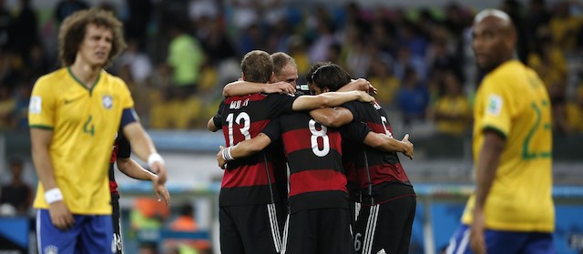 Germany's midfielder Sami Khedira (R) celebrates with teammates after scoring during the semi-final football match between Brazil and Germany at The Mineirao Stadium in Belo Horizonte during the 2014 FIFA World Cup on July 8, 2014. AFP PHOTO / ADRIAN DENNIS
