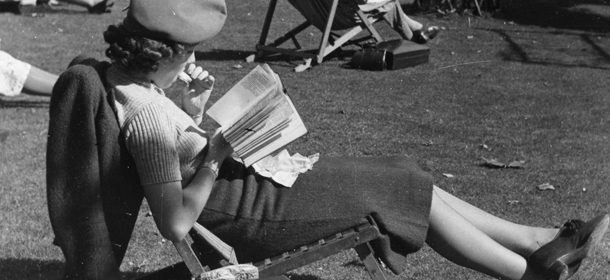 circa 1945: A woman sitting on a deckchair in a park reading a book. (Photo by General Photographic Agency/Getty Images)