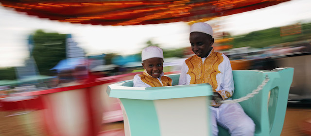 Due bambini alle giostre per Eid al-Fitr a Burgess Park, Londra. 
(Dan Kitwood/Getty Images)