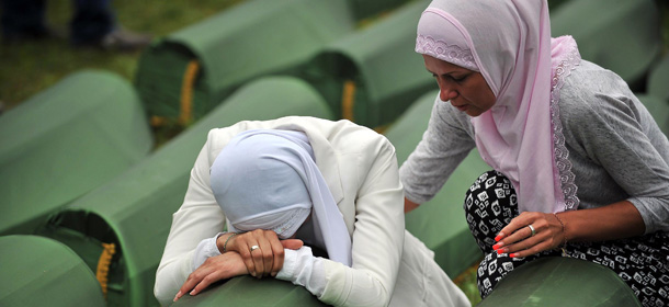 A Bosnian Muslim woman, survivor of the Srebrenica 1995 massacre cries by the coffin of a relative, layed out among others at the memorial cemetery in the village of Potocari near the eastern-Bosnian town of Srebrenica, on July 11, 2014. Several thousand people gathered on July 11 in Srebrenica for the 19th anniversary of the massacre of some 8,000 Muslim males by ethnic Serbs forces, Europe's worst atrocity since World War II. A total of 175 newly-identified massacre victims will be laid to rest after a commemoration ceremony held in Potocari, just outside the ill-fated Bosnian town. AFP PHOTO / ELVIS BARUKCIC (Photo credit should read ELVIS BARUKCIC/AFP/Getty Images)