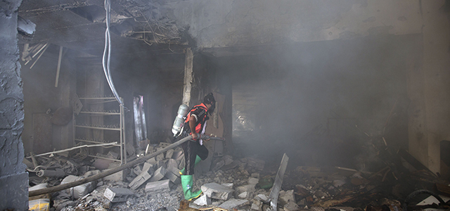 A Palestinian firefighter extinguishes a fire at a house destroyed during an Israeli strike, on July 16, 2014, in Gaza City. So far, Israel's campaign, now in its ninth day, has killed 214 Palestinians, with a Gaza-based rights group saying over 80 percent of them were civilians. In the same period, militants have fired more than 1,200 rockets at Israel, which on Tuesday claimed their first Israeli life. AFP PHOTO/MAHMUD HAMS (Photo credit should read MAHMUD HAMS/AFP/Getty Images)