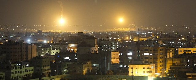 Artillery flares illuminate the sky following an Israeli air strike in Gaza City on July 12, 2014. The Israeli army is warning Palestinians in the northern Gaza Strip to "leave their homes for their own safety," the military said in a statement. AFP PHOTO / MAHMUD HAMS (Photo credit should read MAHMUD HAMS/AFP/Getty Images)