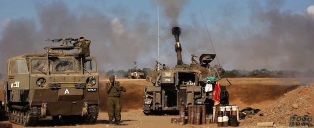 A 155mm artillery, positioned near the Israeli border with the Gaza Strip, fires a projectile towards targets in the Palestinian enclave, on July 17, 2014. Israel and the Islamist Hamas movement have agreed on a ceasefire that will begin at 0300 GMT on Friday, an Israeli official told AFP. AFP PHOTO /MENAHEM KAHANA (Photo credit should read MENAHEM KAHANA/AFP/Getty Images)