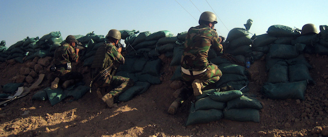 Kurdish security forces take positions at Taza district, south of the oil-rich city of Kirkuk, Iraq, Friday, June 20, 2014. Among rolling wheat fields with machine-gun fire rattling in the distance, Kurdish fighters patrol the new frontier of their autonomous region of northern Iraq, dozens of miles from their official border. In front of them are Islamic militants, behind them is the Kurds' newly captured prize, stretches of oil-rich territory. (AP Photo/Emad Matti)