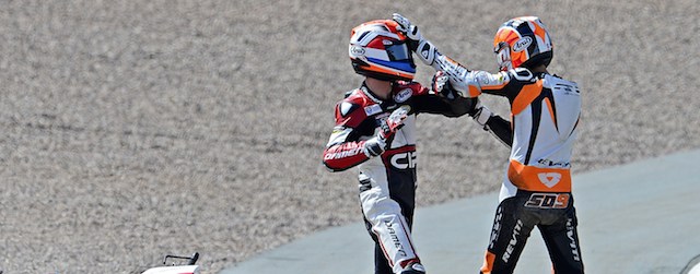 Mahindra rider Bryan Schouten of Netherlands (L) and his compatriot Kalex KTM rider Scott Derouse fight after crashing in the Moto3 race of the Grand Prix of Germany at the Sachsenring Circuit on July 13, 2014 in Hohenstein-Ernstthal, eastern Germany. 
AFP PHOTO / ROBERT MICHAEL (Photo credit should read ROBERT MICHAEL/AFP/Getty Images)