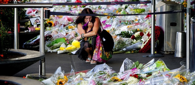 A woman mourns at Schiphol Airport, the Netherlands, on July 23, 2014. The Dutch government has declared a day of national mourning due to the crash of flight MH17 in Ukraine. At 04.00 PM, when the first 50 bodies of the 298 victims will arrive on Eindhoven Airport, the country will hold a minutes silence. AFP PHOTO/ANP ROBIN VAN LONKHUIJSEN netherlands out (Photo credit should read ROBIN VAN LONKHUIJSEN/AFP/Getty Images)