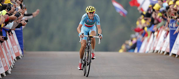 Italy's Vincenzo Nibali crosses the finish line to win the tenth stage of the Tour de France cycling race over 161.5 kilometers (100.4 miles) with start in Mulhouse and finish in La Planche des Belles Filles, France, Monday, July 14, 2014. (AP Photo/Peter Dejong)