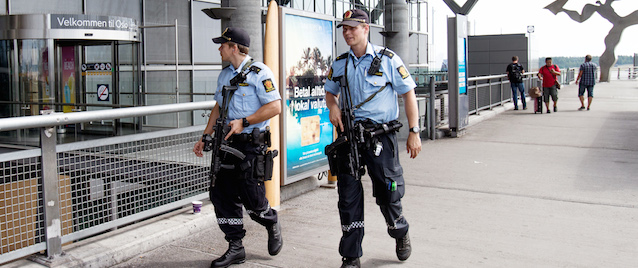 Armed Police patrol outside the terminal building at Oslo Airport, Thursday, July 24, 2014. Norway's intelligence service says it has been warned of an imminent "concrete threat" against the nation from people with links to Islamic fighters in Syria. (AP Photo/NTB Scanpix, Audun Braastad) NORWAY OUT