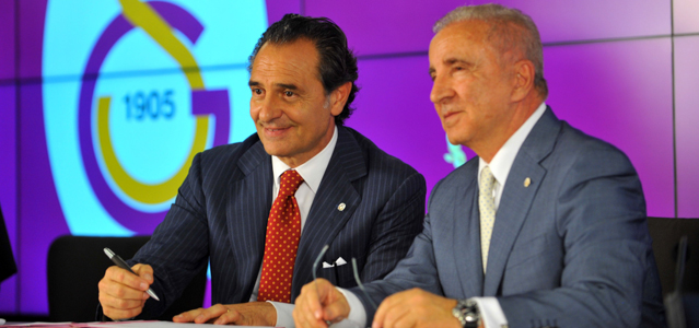 Former Italy's football manager Cesare Prandelli (L) signs his new contract with Turkish businessman and Galatasaray football club's president Unal Aysal on July 8, 2014 during the signing ceremony held at the TT Arena stadium in Istanbul. Prandelli immediately put behind him the disappointment of his country's first round ejection from the World Cup, signing a two year deal with Istanbul giants Galatasaray worth at least 2.3 million euros a year. AFP PHOTO / OZAN KOSE (Photo credit should read OZAN KOSE/AFP/Getty Images)