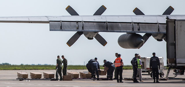 KHARKIV, UKRAINE - JULY 23: Coffins containing the bodies of victims of the crash of Malaysia Airlines flight MH17 are prepared for loading onto a plane which will take them to the Netherlands on July 23, 2014 in Kharkiv, Ukraine. Malaysia Airlines flight MH17 was travelling from Amsterdam to Kuala Lumpur when it crashed killing all 298 on board including 80 children. The aircraft was allegedly shot down by a missile and investigations continue over the perpetrators of the attack. (Photo by Brendan Hoffman/Getty Images)