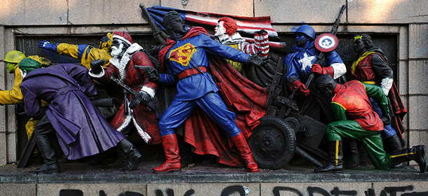 A picture taken in Sofia on June 17, 2011, shows the figures of Soviet soldiers at the base of the Soviet Army monument, painted by an unknown artist to resemble U.S. comic book heroes and characters from popular culture like Santa Claus and Ronald McDonald, the mascot of fast-food chain giant McDonald's. Over two decades after the toppling of the regime they glorified, the megalomaniac monuments of the communist era are still standing, setting a quandary for Bulgarian authorities, who can neither maintain nor dismantle them. The inscription below them reads: "Abreast With the Times" AFP PHOTO / NIKOLAY DOYCHINOV 
TO GO WITH AFP STORY BY VESSELA SERGUEVA - BULGARIA-HISTORY-COMMUNISM-CULTURE (Photo credit should read NIKOLAY DOYCHINOV/AFP/Getty Images)