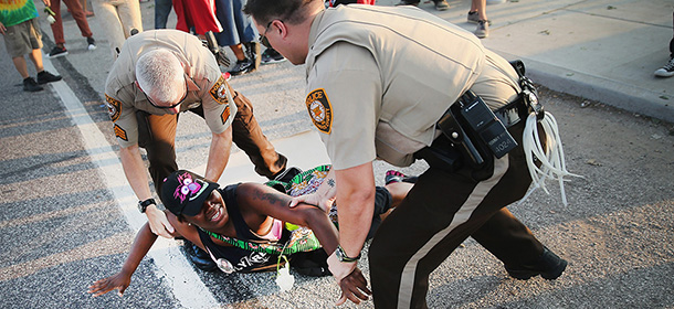 FERGUSON, MO - AUGUST 19: A demonstrator is arrested while protesting the killing of teenager Michael Brown on August 19, 2014 in Ferguson, Missouri. Brown was shot and killed by a Ferguson police officer on August 9. Despite the Brown family's continued call for peaceful demonstrations, violent protests have erupted nearly every night in Ferguson since his death. (Photo by Scott Olson/Getty Images)