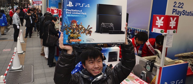 A customer reacts after buying Sony's PlayStation 4 video game console in Tokyo on February 22, 2014. Diehard gamers in Japan who began queuing earlier this week finally got their hands on a new PlayStation 4 as Sony unleashed its console on home turf in a midnight launch. AFP PHOTO / KAZUHIRO NOGI (Photo credit should read KAZUHIRO NOGI/AFP/Getty Images)