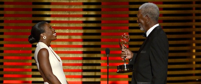 IMAGE DISTRIBUTED FOR THE TELEVISION ACADEMY - Morgan Freeman, right, presents the award for outstanding guest actress in a comedy series on stage to Uzo Aduba for her work on “Orange Is the New Black” at the Television Academy's Creative Arts Emmy Awards at the Nokia Theater L.A. LIVE on Saturday, Aug. 16, 2014, in Los Angeles. (Photo by Phil McCarten/Invision for the Television Academy/AP Images)
