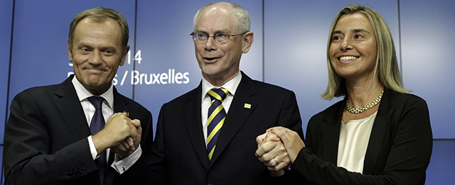 European Council President Herman Van Rompuy, center, holds the hands of Polish Prime Minister Donald Tusk, left, and Italian Foreign Minister Federica Mogherini during a media conference at an EU summit in Brussels, Saturday, Aug. 30, 2014. European Union leaders have nominated Italy's Mogherini to become the 28-nation bloc's new foreign policy chief for the next five years. The EU leaders also elected Polish Prime Minister Donald Tusk to succeed European Council President Herman Van Rompuy in December as EU summit chairman and behind-the-scenes broker of compromises among national leaders. (AP Photo/Yves Logghe)