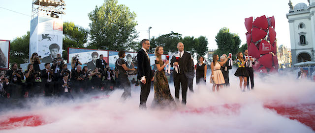 Actress Cristiana Capotondi, second from left, and other guests pose for photographers as they arrive for the screening of The Price of Fame during the 71st edition of the Venice Film Festival in Venice, Italy, Thursday, Aug. 28, 2014 (AP Photo/Andrew Medichini)