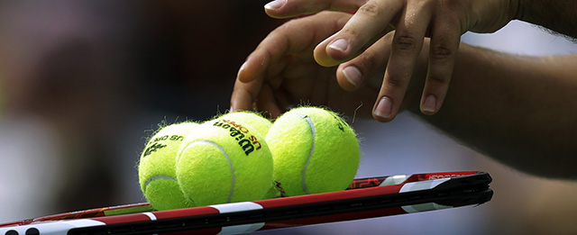 A ball runner hands balls to Marcos Baghdatis, of Cyprus, during a third round match against Stanislas Wawrinka of Switzerland, at the 2013 U.S. Open tennis tournament, Sunday, Sept. 1, 2013, in New York. (AP Photo/Mike Groll)