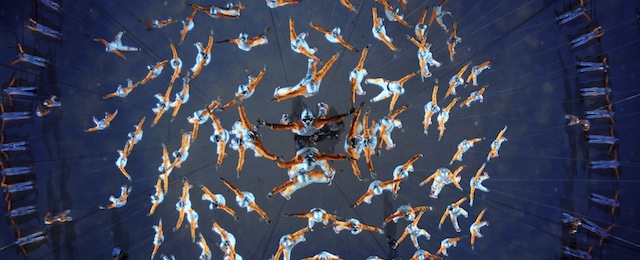 In this photo taken Thursday Aug. 14, 2014 performers tied to wires rehearse for the opening ceremony of the 2014 Nanjing Youth Olympic Games which opens Aug 16, 2014 in Nanjing in east China's Jiangsu province. (AP Photo) CHINA OUT