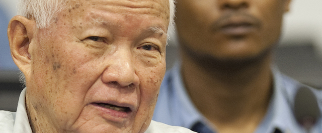 In this photo released by the Extraordinary Chambers in the Courts of Cambodia, Khieu Samphan, left, former Khmer Rouge head of state, looks on before his final statements at the U.N.-backed war crimes tribunal in Phnom Penh, Cambodia, Thursday, Oct. 31, 2013. Former Khmer Rouge leader Nuon Chea has denied all charges against him on the last day of a trial for leaders of the Cambodian regime widely blamed for the deaths of some 1.7 million people. (AP Photo/Extraordinary Chambers in the Courts of Cambodia, Mark Peters)