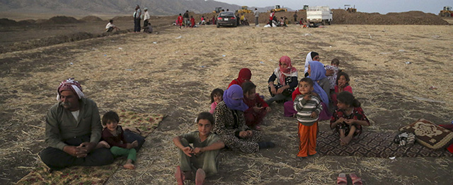 Displaced Iraqis from the Yazidi community settle outside the camp of Bajid Kandala at Feeshkhabour town near the Syria-Iraq border, Iraq Saturday, Aug. 9, 2014. The displacement of at least tens of thousands of Yazidis - Kurdish speakers of an ancient Mesopotamian faith- meant yet another Iraqi minority was peeled away as extremists continue their sweep of Iraq, seizing territory they brutally administer. The Islamic State group fighters already caused the expulsion of Iraq’s Christians, Shiite Muslims and adherents of the tiny Shabak faith. The hardliners see other religious groups as heretics who may be killed or forced to submit to their rule. (AP Photo/ Khalid Mohammed)