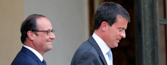French Prime Minister Manuel Valls, right, leaves after a meeting with French President Francois Hollande at the Elysee Palace in Paris, Monday, Aug. 25, 2014. France’s Socialist government dissolved on Monday after open feuding in the Cabinet over how much cutting, or spending, will revive the country’s stagnant economy. The country is under pressure from the 28-nation European Union to get its finances in order, but Economy Minister Arnaud Montebourg has questioned whether austerity will really kick start French growth. (AP Photo/Christophe Ena)