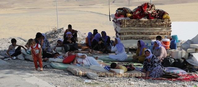 Displaced Iraqis from the Yazidi community settle at the Qandil mountains near the Turkish border outside Zakho, 300 miles (475 kilometers) northwest of Baghdad, Iraq, Saturday, Aug. 16, 2014. Islamic extremists shot 80 Yazidi men to death in Iraq, lining them up in small groups and opening fire with assault rifles before abducting their wives and children, officials and eyewitnesses reported Saturday. (AP Photo/ Khalid Mohammed)