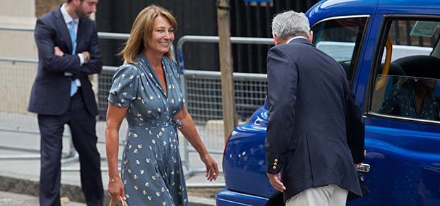 Michael Middleton (R) opens the door of a taxi for his wife Carole (2nd L) as they leave after visiting their daughter Catherine, Duchess of Cambridge, Prince William, and their new baby at St Mary's Hospital in London, on July 23, 2013. Britain's Prince William and his wife Kate on Tuesday thanked staff at the hospital where their baby son was born, as the world waited for a name and hopefully a glimpse of the future king. AFP PHOTO / ANDREW COWIE (Photo credit should read ANDREW COWIE/AFP/Getty Images)