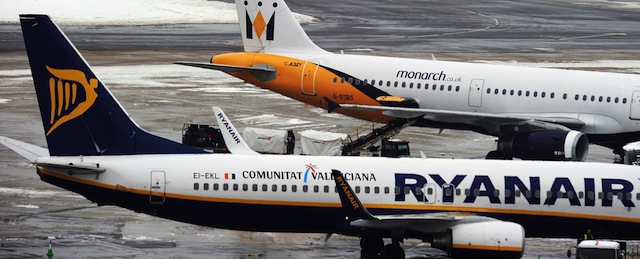 A snow plough drives past Monarch and Ryanair planes at Gatwick airport, West Sussex, on December 19, 2010. Ryanair was forced to cancel 84 of its flights and Monarch airlines Managing Director Tim Jeans has called for a reassessment of the UK's transport capabilities. Britain was hit by more blizzards that shut its biggest airports on the busiest weekend for travellers before Christmas and hit road and rail traffic. Gatwick airport said it was providing beds and cots, distributing thousands of blankets, hundreds of bottles of water and food and making showers and washing facilities available free of charge. AFP PHOTO / Carl de Souza (Photo credit should read CARL DE SOUZA/AFP/Getty Images)