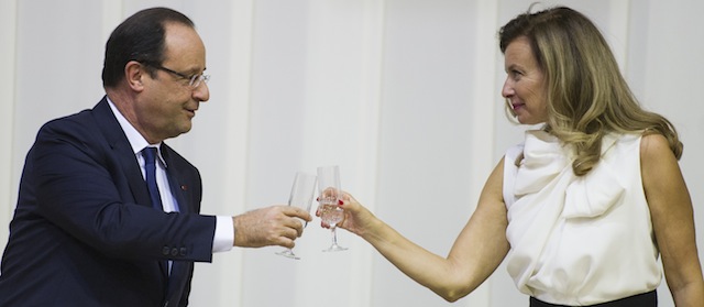 French President Fran√ßois Hollande (L) toasts with his partner Valerie Trierweiler (R) during a state dinner with South African President on October 14, 2013 in Pretoria. On a two-day state visit to South Africa, Hollande told that an agreement has been penned between French energy firm "GDF Suez and South Africa for a thermal power plant to the tune of 1,5 billion euros and also for a solar plant." AFP PHOTO / FRED DUFOUR (Photo credit should read FRED DUFOUR/AFP/Getty Images)