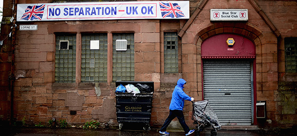 GLASGOW, SCOTLAND - SEPTEMBER 05: A man walks past the Blue Star social club in Govan as campaigning continues in the Scottish Referendum on September 5, 2014 in Glasgow, Scotland. There is now just two weeks of campaigning left before voters go to the polls to vote yes or no on whether Scotland should become an independent country. (Photo by Jeff J Mitchell/Getty Images)