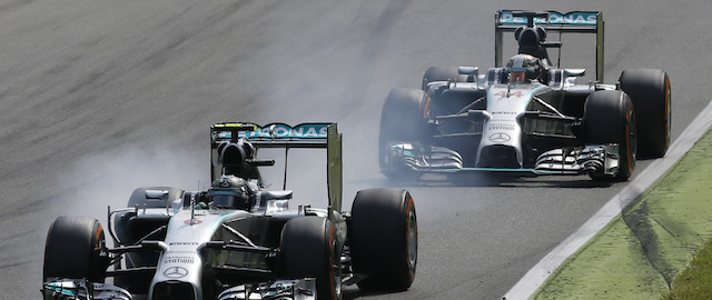 Mercedes driver Nico Rosberg of Germany, foreground, brakes his car before driving off the track allowing his teammate Mercedes driver Lewis Hamilton of Britain to overtake him during the Italian Formula One Grand Prix at the Monza racetrack, in Monza, Italy, Sunday, Sept. 7, 2014. (AP Photo/Antonio Calanni)