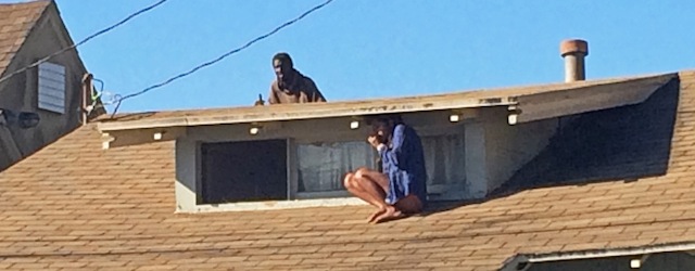 FILE - In this Wednesday, Sept. 24, 2014 file photo, Melora Rivera, who fled her house through an attic window to escape an intruder, seen on the roof behind her, waits for help after an early-morning break-in at her house in the Venice neighborhood of Los Angeles. The intruder, later identified as Christian Hicks, was arrested by Los Angeles police officers, Friday, Sept. 26, 2014. ( AP Photo/Venice311.org, Alex Thompson, File)