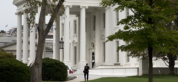 A security member of the Secret Service approaches the North Portico of the White House in Washington Monday, Sept. 29, 2014. The intruder who climbed a fence Sept. 19, 2014 made it farther inside the White House than the Secret Service has publicly acknowledged, the Washington Post and New York Times newspapers reported Monday. The disclosures came on the eve of a congressional oversight hearing with the director of the embattled agency assigned to protect the president's life. (AP Photo/Jacquelyn Martin)