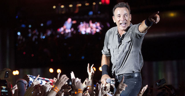 Bruce Springsteen performs among fans during the Rock in Rio music festival in Rio de Janeiro, Brazil, Sunday, Sept. 22, 2013. The week long festival will feature a list of headliners including Muse, Justin Timberlake, Metallica, Bon Jovi, and Bruce Springsteen. (AP Photo/Felipe Dana)