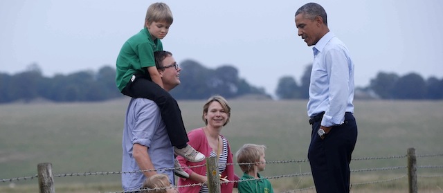 President Barack Obama meets a family in a field as he visits Stonehenge after leaving the NATO summit in Newport, Wales, Friday, Sept. 5, 2014. (AP Photo/Charles Dharapak)