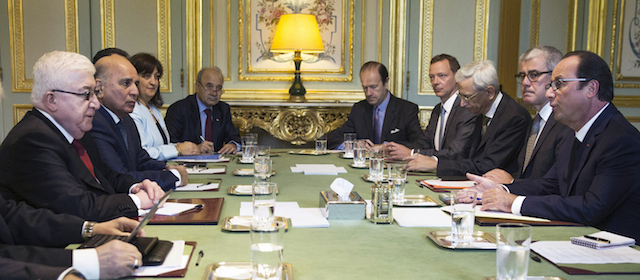 French President Francois Hollande, second right, discusses with his Iraqi counterpart 
Fouad Massoum, second left, at the Elysee Palace in France, Monday, Sept.15 2014. France wants to invite Iran to an international conference it’s hosting Monday on what to do in Iraq, and is pressing other participants to agree _ including the US. This is part of what looks like a shift in French diplomacy toward a more pragmatic tack with Iran, amid everything happening right now in Iraq and Syria. (AP Photo/Etienne Laurent, Pool)