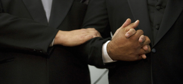 Brazilians Marcelo Sales Leite (L), and his groom Roberto Fraga da Silva, hold hands as they get married during a collective gay marriage ceremony, in Sao Paulo, Brazil, on June 13, 2009. The 13th edition of the world's biggest Gay Pride Parade is expected to hold over three million people at the financial centre of Sao Paulo Sunday. AFP PHOTO/Daniel KFOURI (Photo credit should read DANIEL KFOURI/AFP/Getty Images)
