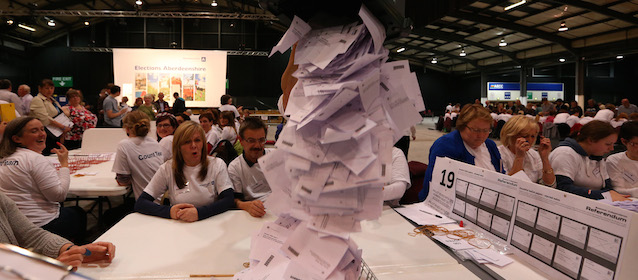 Ballot boxes are opened as counting begins in the Scottish Independence Referendum for the Aberdeenshire Council area, Aberdeen, Scotland, Thursday, Sept. 18, 2014. As the polls closed late Thursday and the vote counting began, many Scots settled in to stay up all night in homes and bars to watch the results. A nationwide count began immediately at 32 regional centers across Scotland. (AP Photo/Scott Heppell)