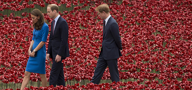 Britain's Duke of Cambridge Prince William, center, his wife Kate the Duchess of Cambridge and his brother Prince Harry visit a ceramic poppy art installation by ceramic artist Paul Cummins entitled 'Blood Swept Lands and Seas of Red' for its official unveiling in the dry moat of the Tower of London in London, Tuesday, Aug. 5, 2014. Their visit to the work in progress installation, which currently consists of approximately 120,000 ceramic poppies and will finish with 888,246 poppies, was held Tuesday to mark the centenary of World War I. The final ceramic poppy will be placed on Armistice Day on November 11, with each poppy representing a British and Commonwealth military fatality from World War I. (AP Photo/Matt Dunham)