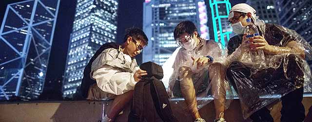 HONG KONG - SEPTEMBER 29: Protesters sit on top of a parking ramp in the Central District on September 29, 2014 in Hong Kong. Thousands of pro democracy supporters have remained in the streets of Hong Kong for another day of protests. Protestors are unhappy with Chinese government's plans to vet candidates in Hong Kong's 2017 elections. (Photo by Anthony Kwan/Getty Images)