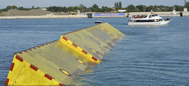 Movable underwater panels emerge from the lagoon Saturday, Oct. 12, 2013, during the first official test of Venice movable barriers designed to rise from the seabed and prevent severe flooding in Venice, Italy. The project is named "Moses," after the Old Testament figure who parted the Red Sea. (AP Photo/Luigi Costantini)