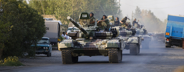 In this Saturday, Aug. 2, 2014, photo a convoy of Azerbaijan's Army tanks moves in the direction of Agdam, Azerbaijan. Recent days have seen a sharp escalation in fighting between Azerbaijan and Armenia around a tense line of control around Nagorno-Karabakh. (AP Photo/Abbas Atilay )