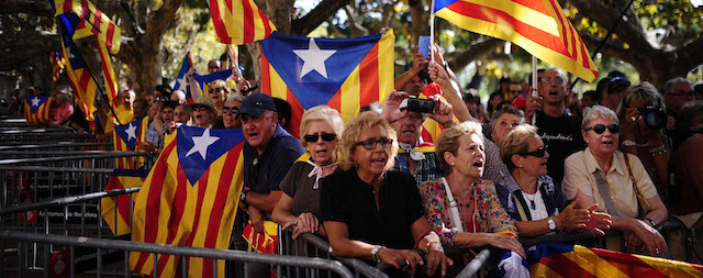 People wave “estelada” flags, that symbolize Catalonia's independence, during a demonstration calling for the independence of Catalonia in Barcelona, Spain, Friday, Sept. 19, 2014. A day after Scotland rejected breaking away from Britain, the regional parliament in Spain's Catalonia is expected to grant its leader the power to call a secession referendum that the central government in Madrid says would be illegal. Spanish Prime Minister Mariano Rajoy has vowed to prevent the Nov. 9 vote that separatist Catalans want to hold in the wealthy Mediterranean region of 7.5 million people. Spain's constitution doesn't allow referendums that do not include all Spaniards and experts say Spain's Constitutional Court would rule the vote illegal. The referendum in Catalonia wouldn't result in secession; it would ask Catalans whether they favor secession. If the answer is Yes, Catalan regional leader Artur Mas says that would give him a political mandate to negotiate a path toward independence. (AP Photo/Manu Fernandez)