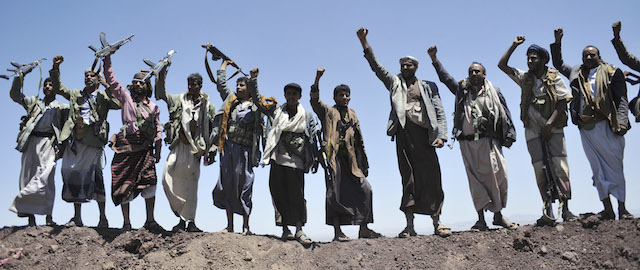 Hawthi Shiite rebels chant slogans at the compound of the army's First Armored Division, after they took it over, in Sanaa, Yemen, Monday, Sept. 22, 2014. Heavily armed Yemeni Shiite militiamen took over the headquarters and house of a powerful army general allied to Sunni Islamists on Monday and set up checkpoints across the capital, Sanaa, after sweeping across the city as the general and his allies fled and went into hiding. (AP Photo/Hani Mohammed)